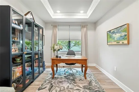 a bedroom with a bed mirror and a window