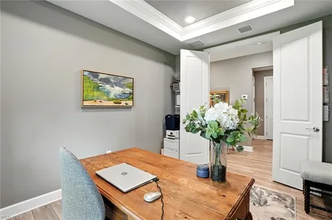 a bedroom with a bed and a flat tv screen on dresser