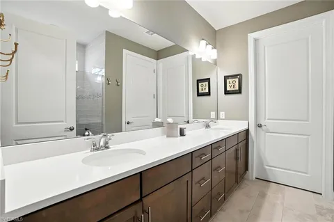 a bathroom with a sink a toilet and shower curtain