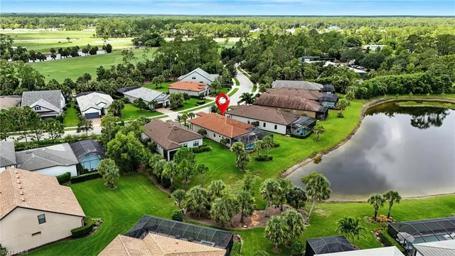 an aerial view of residential houses with outdoor space and trees