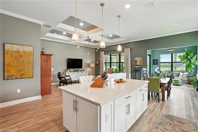 a large white kitchen with a large island