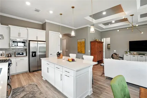 a large kitchen with a table and chairs