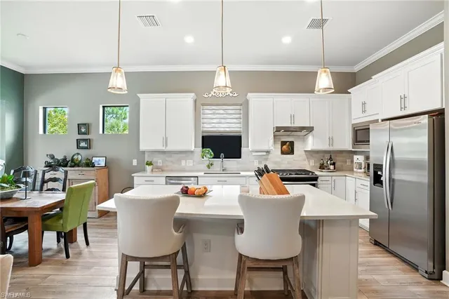 a large kitchen with a table and chairs