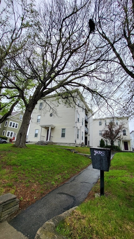 162 Riverside Street, Unit 2 Lowell, MA 01854 - Photo 1 of 12 a front view of a house with garden