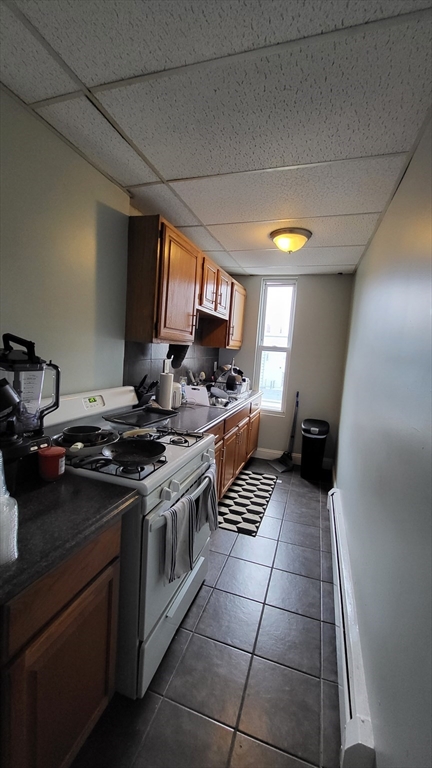 162 Riverside Street, Unit 2 Lowell, MA 01854 - Photo 2 of 12 a kitchen with a stove and a sink