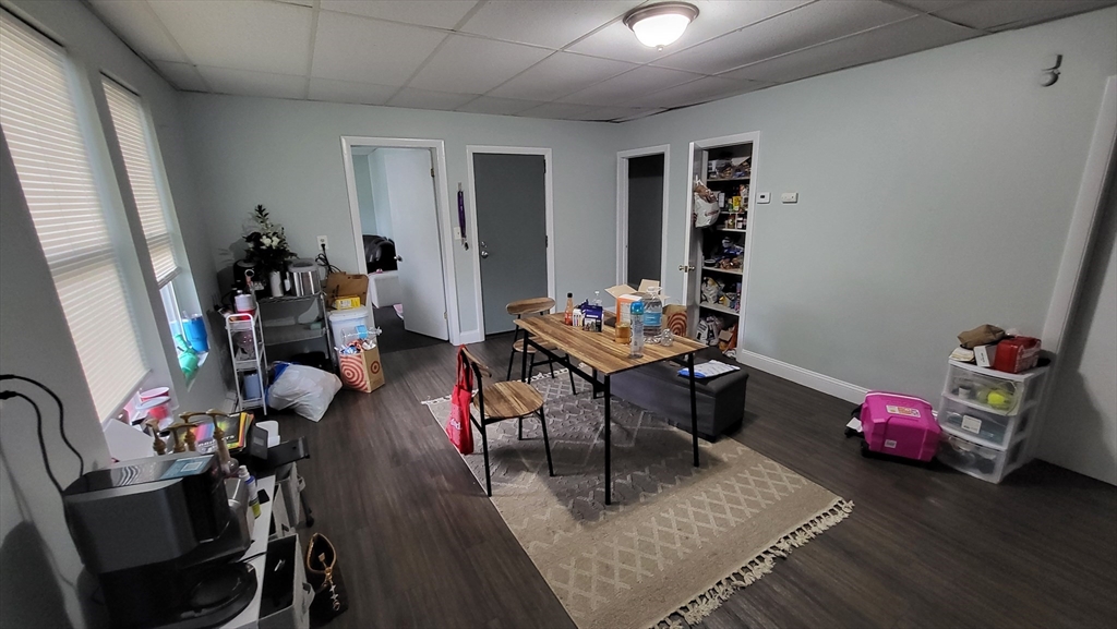 162 Riverside Street, Unit 2 Lowell, MA 01854 - Photo 4 of 12 a living room with furniture and a wooden floor