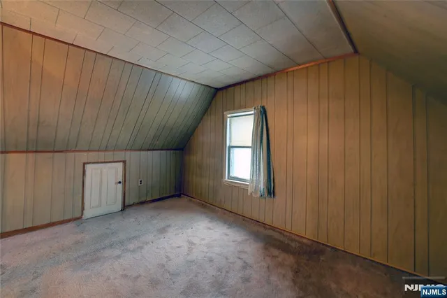 an empty room with a ceiling fan and a window