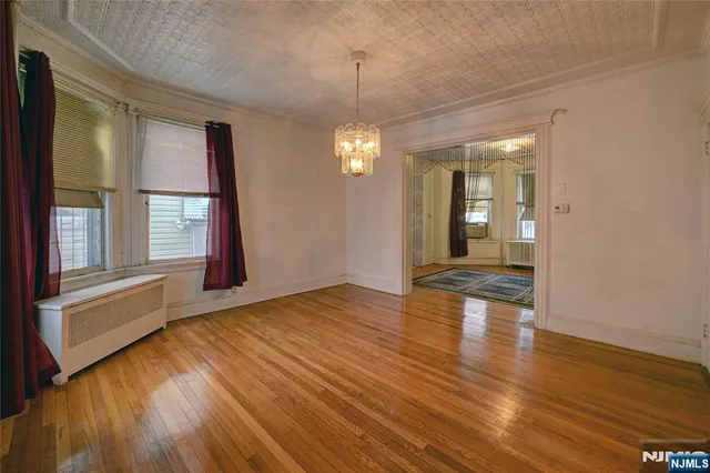 a view of a room with wooden floor and window