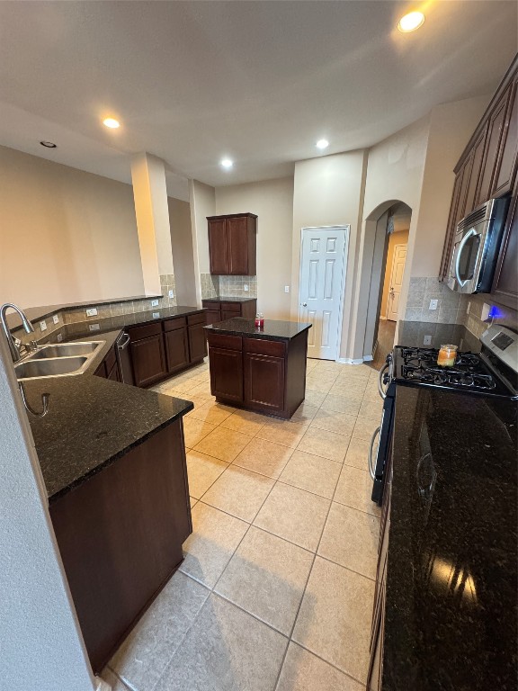 3219 Witney Way Fresno, TX 77545 - Photo 5 of 23 a kitchen with stainless steel appliances granite countertop a sink and a stove