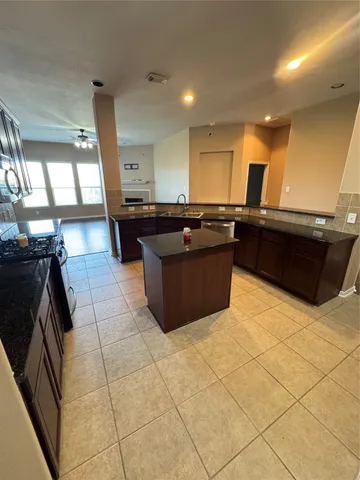 a kitchen with a sink and a stove top oven