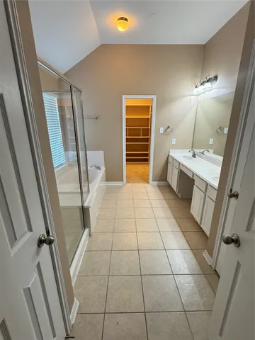 a bathroom with a sink a toilet a mirror and tub