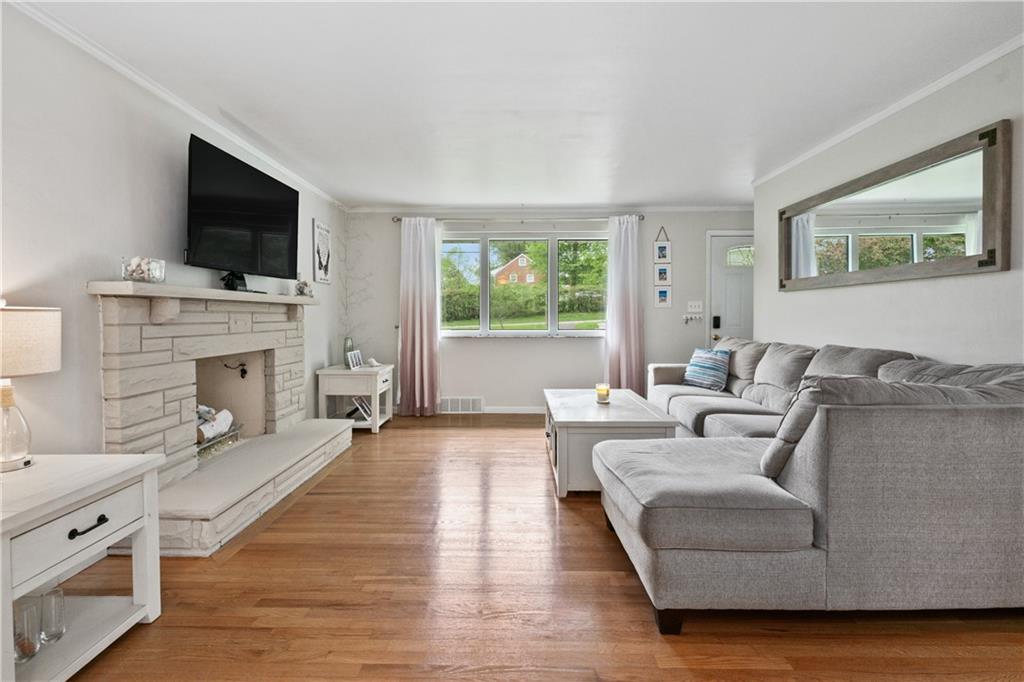5431 Hamilton Road Gibsonia, PA 15044 - Photo 5 of 28 a living room with fireplace furniture and a flat screen tv