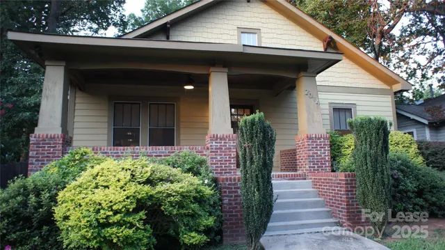 a view of a house with potted plants