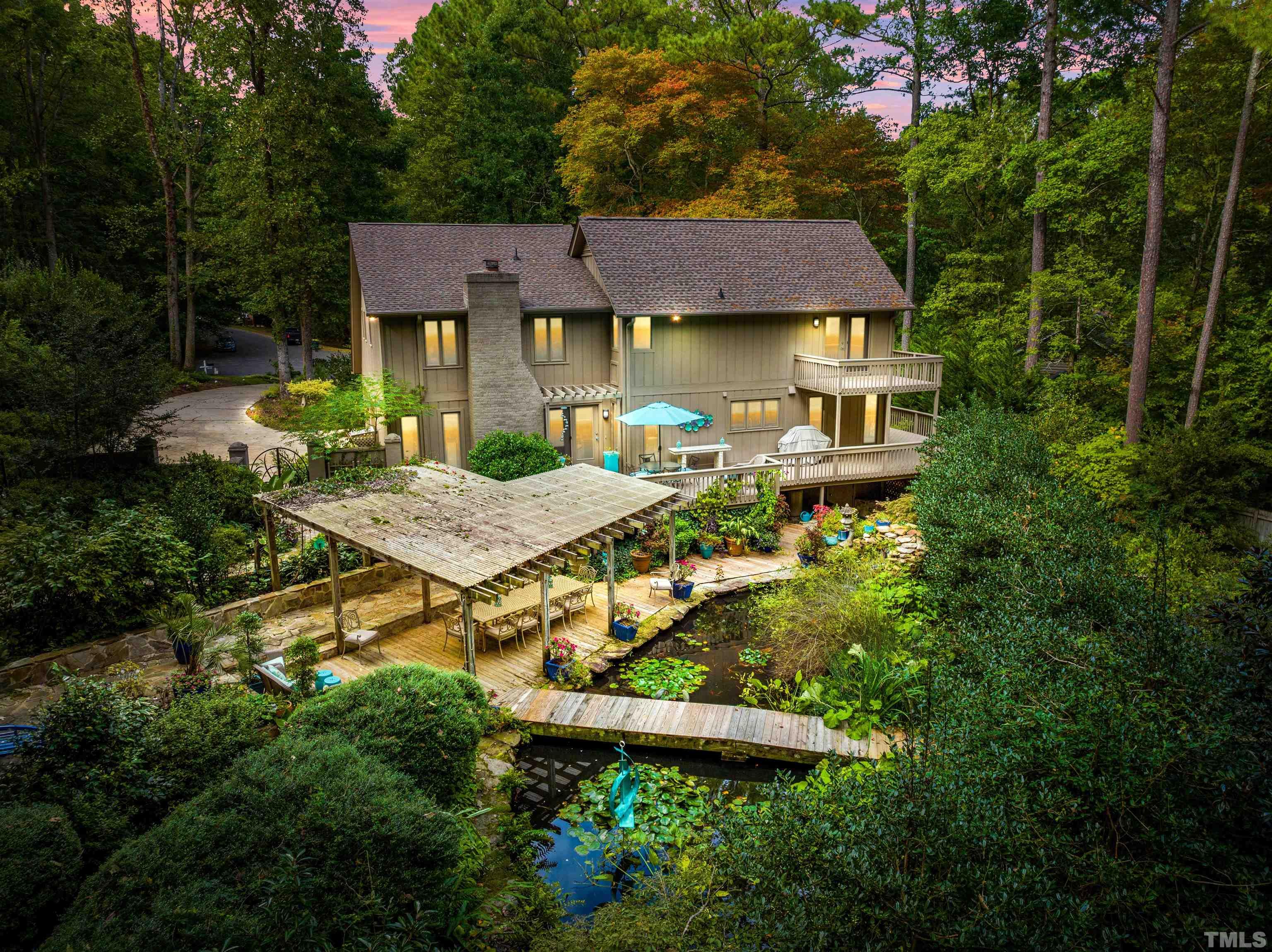 10101 East Roadstead Way Raleigh, NC 27613 - Photo 61 of 68 a aerial view of a house with table and chairs under an umbrella