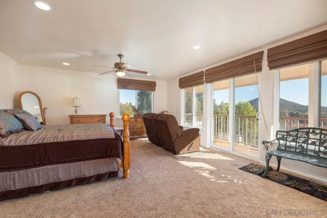 a spacious bedroom with a bed and a large window
