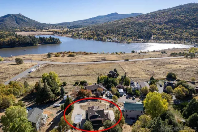 an aerial view of a house with a lake view