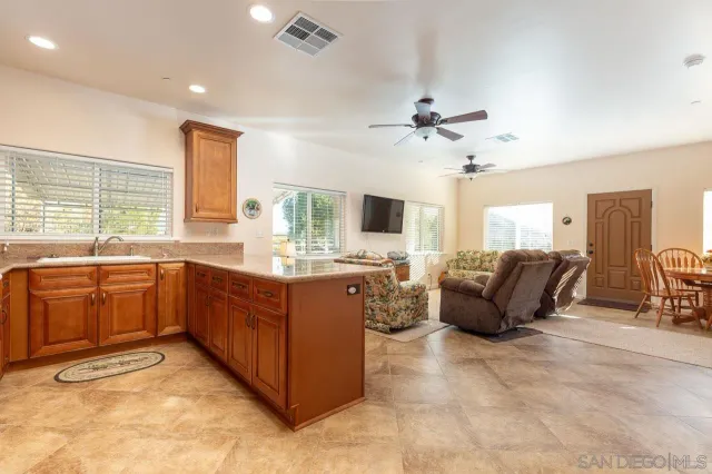 a kitchen with stainless steel appliances granite countertop a sink and cabinets