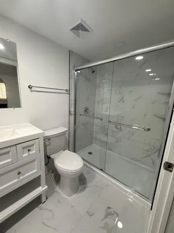 a bathroom with a sink toilet and shower