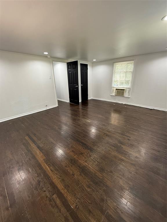 4610 Victor Street, Unit 5 Dallas, TX 75246 - Photo 7 of 13 an empty room with wooden floor and windows