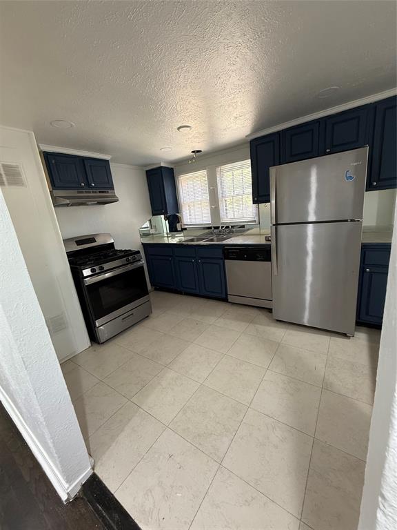 4610 Victor Street, Unit 5 Dallas, TX 75246 - Photo 8 of 13 a kitchen with granite countertop a refrigerator and a stove top oven