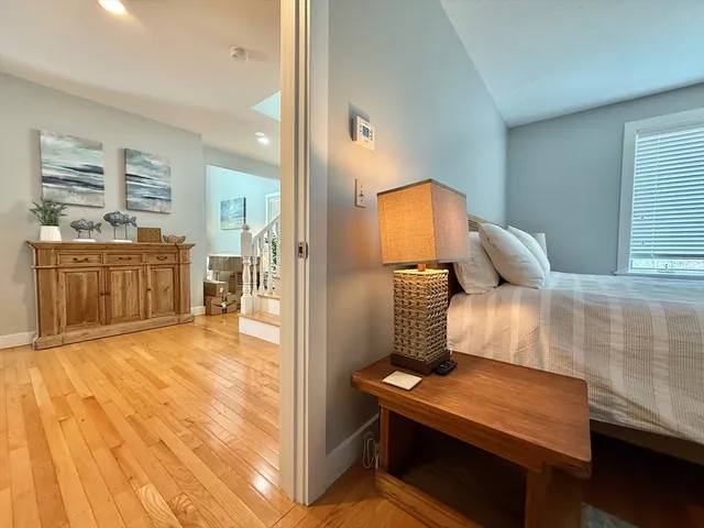 a bedroom with a bed and wooden floor