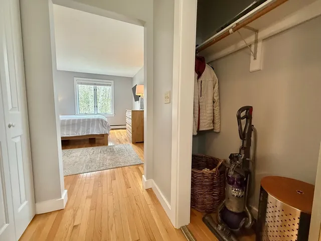 a view of hallway with wooden floor