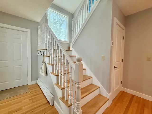 a view of entryway and hall with wooden floor