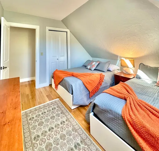 a bedroom with two beds and a lamp