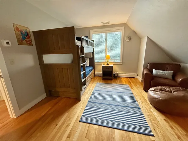 a view of a living room with furniture and wooden floor