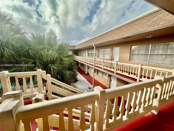 a view of an apartment with a swimming pool