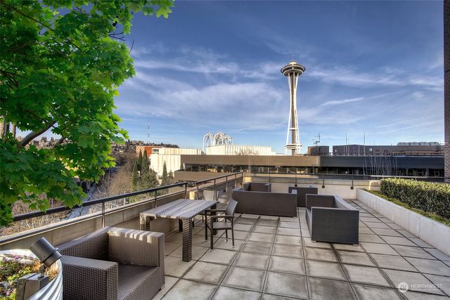 a living room with furniture potted plant and a large window