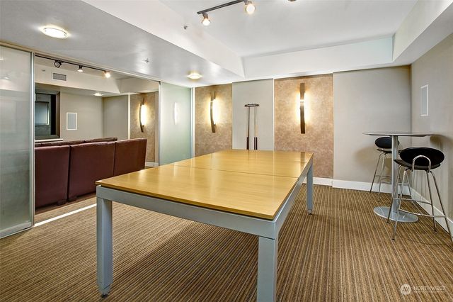 an outdoor sitting area with couch and chairs