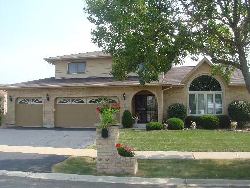 403 Danielle Road Matteson, IL 60443 - Photo 1 of 1 a front view of a house with a yard and garage