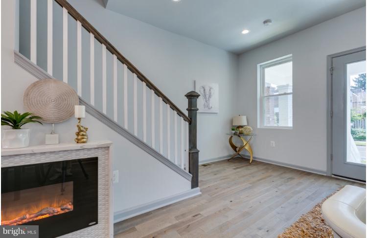 717 Rittenhouse Street Northwest Washington, DC 20011 - Photo 10 of 27 a living room with wooden floor and a fireplace