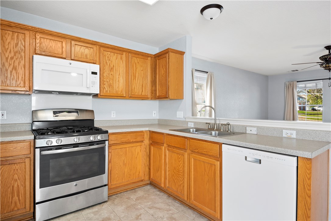 6240 Negley Kyle, TX 78640 - Photo 1 of 1 a kitchen with granite countertop a sink stove and cabinets