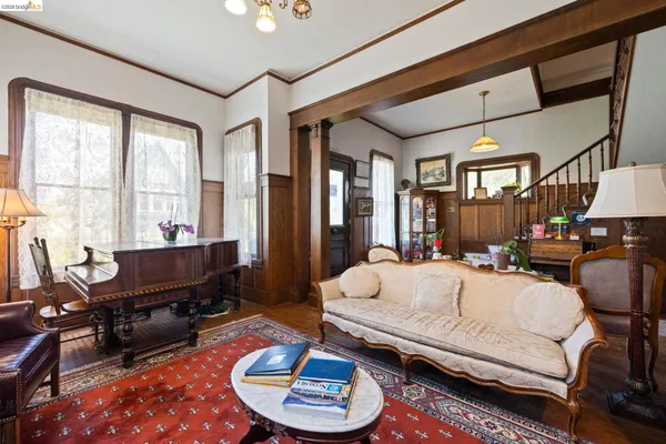 a living room with furniture a flat screen tv and a floor to ceiling window