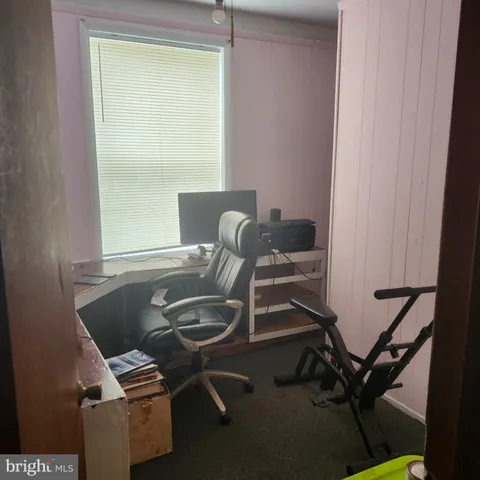 an empty room with a chandelier fan