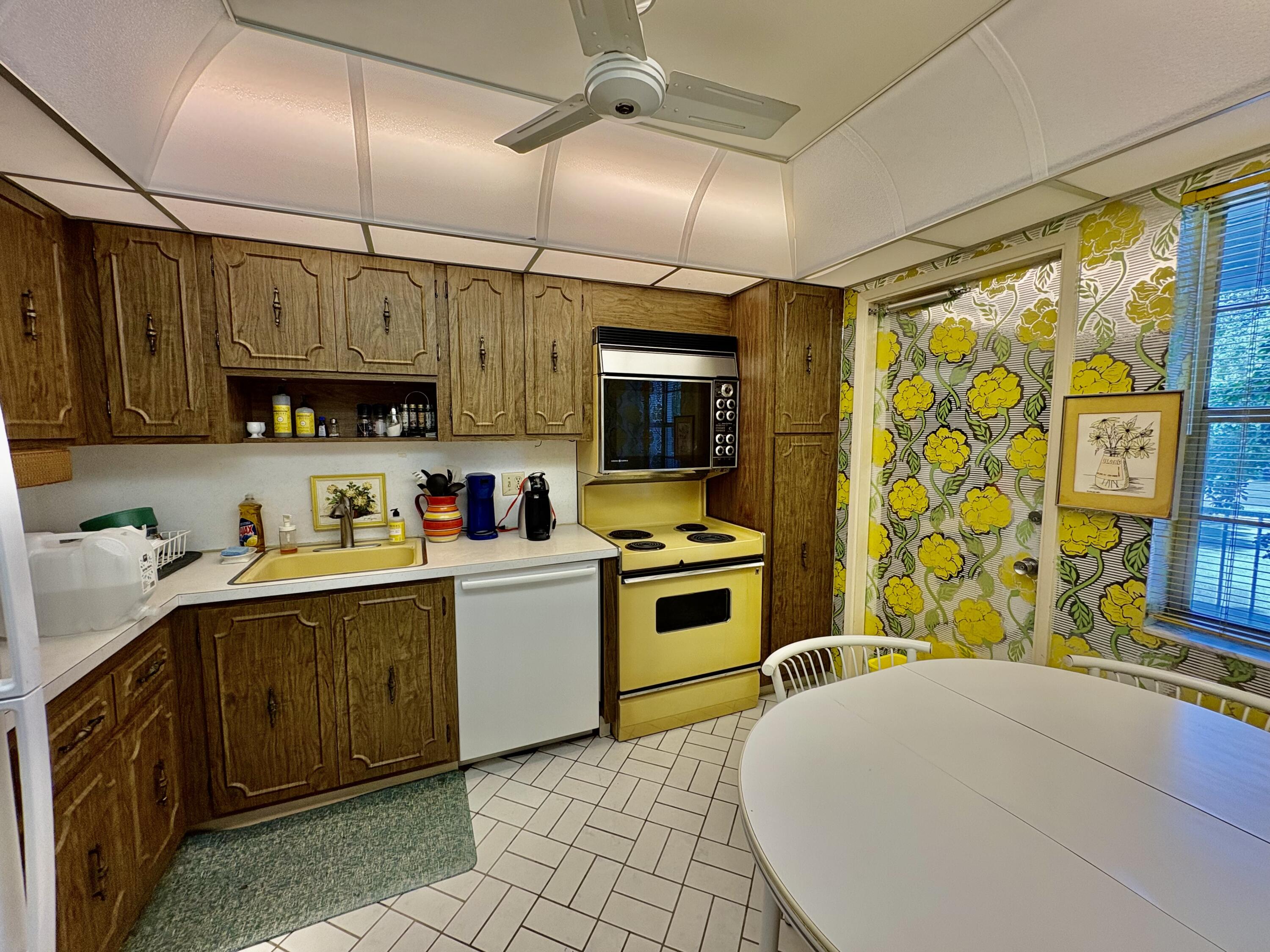 3150 North Course Lane, Unit 202 Pompano Beach, FL 33069 - Photo 12 of 18 a kitchen with a sink a stove and cabinets