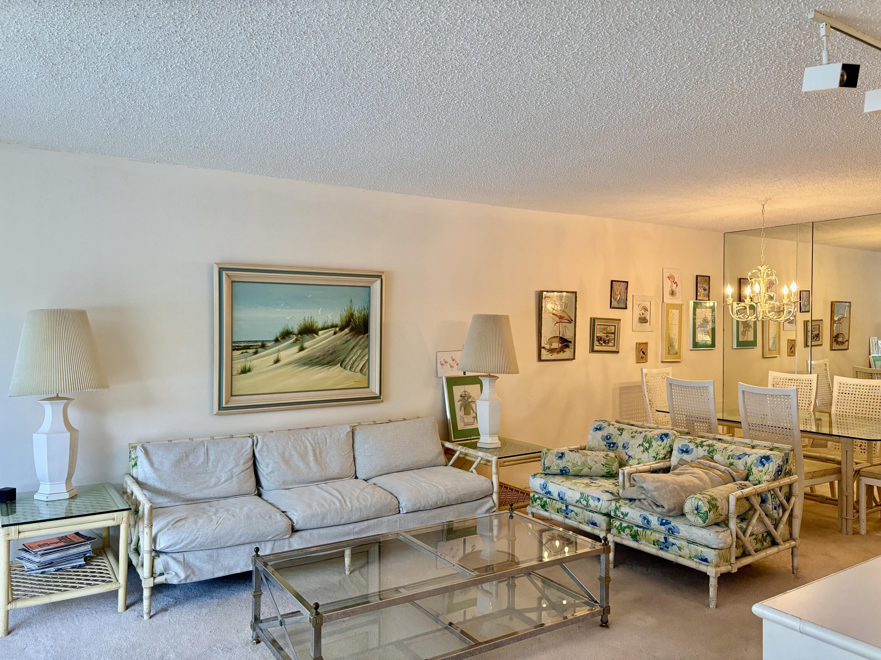 3150 North Course Lane, Unit 202 Pompano Beach, FL 33069 - Photo 2 of 18 a living room with furniture and a table