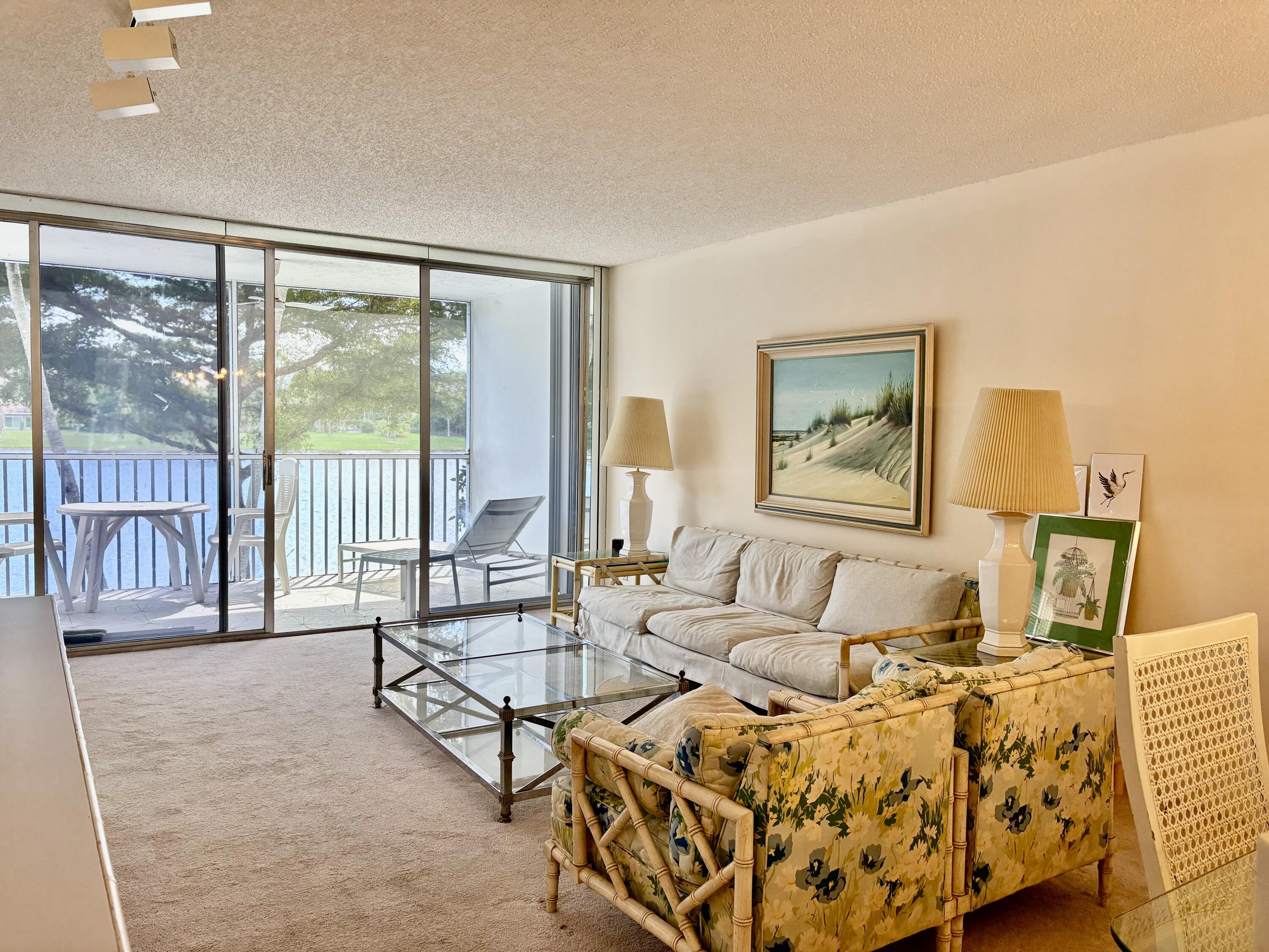 3150 North Course Lane, Unit 202 Pompano Beach, FL 33069 - Photo 4 of 18 a living room with furniture and a large window