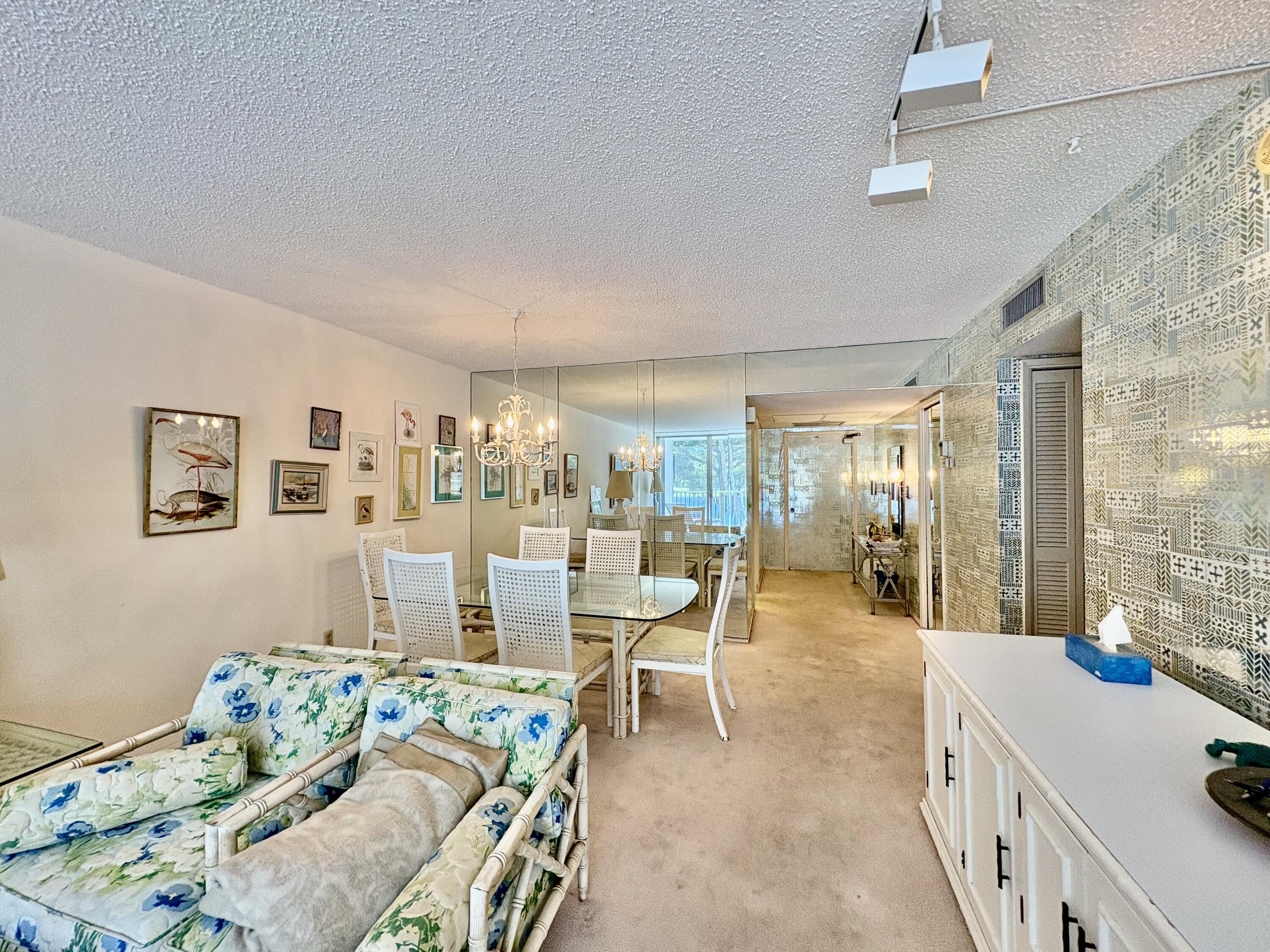 3150 North Course Lane, Unit 202 Pompano Beach, FL 33069 - Photo 5 of 18 a living room with furniture and a table