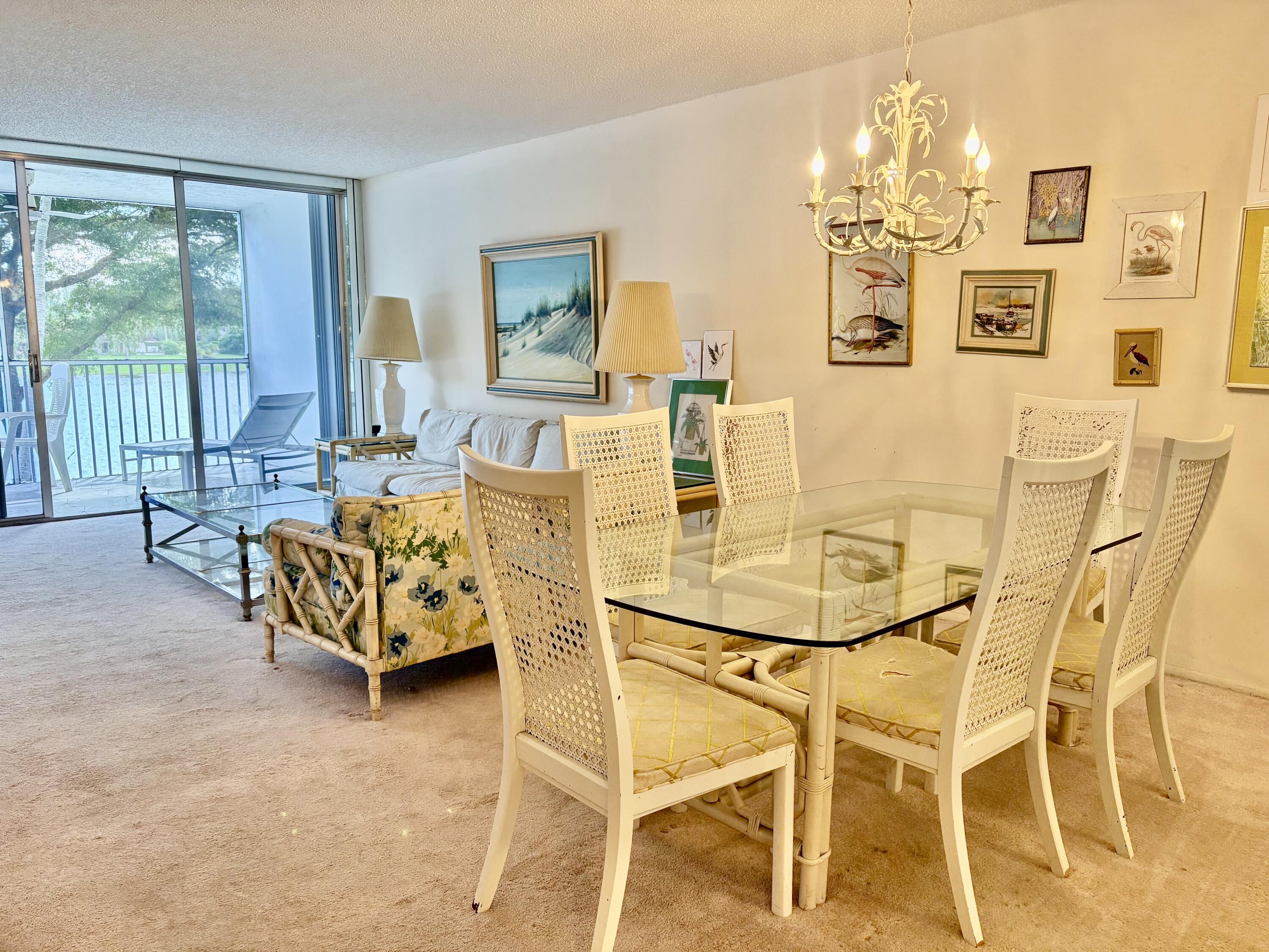 3150 North Course Lane, Unit 202 Pompano Beach, FL 33069 - Photo 6 of 18 a dining room with furniture and chandelier
