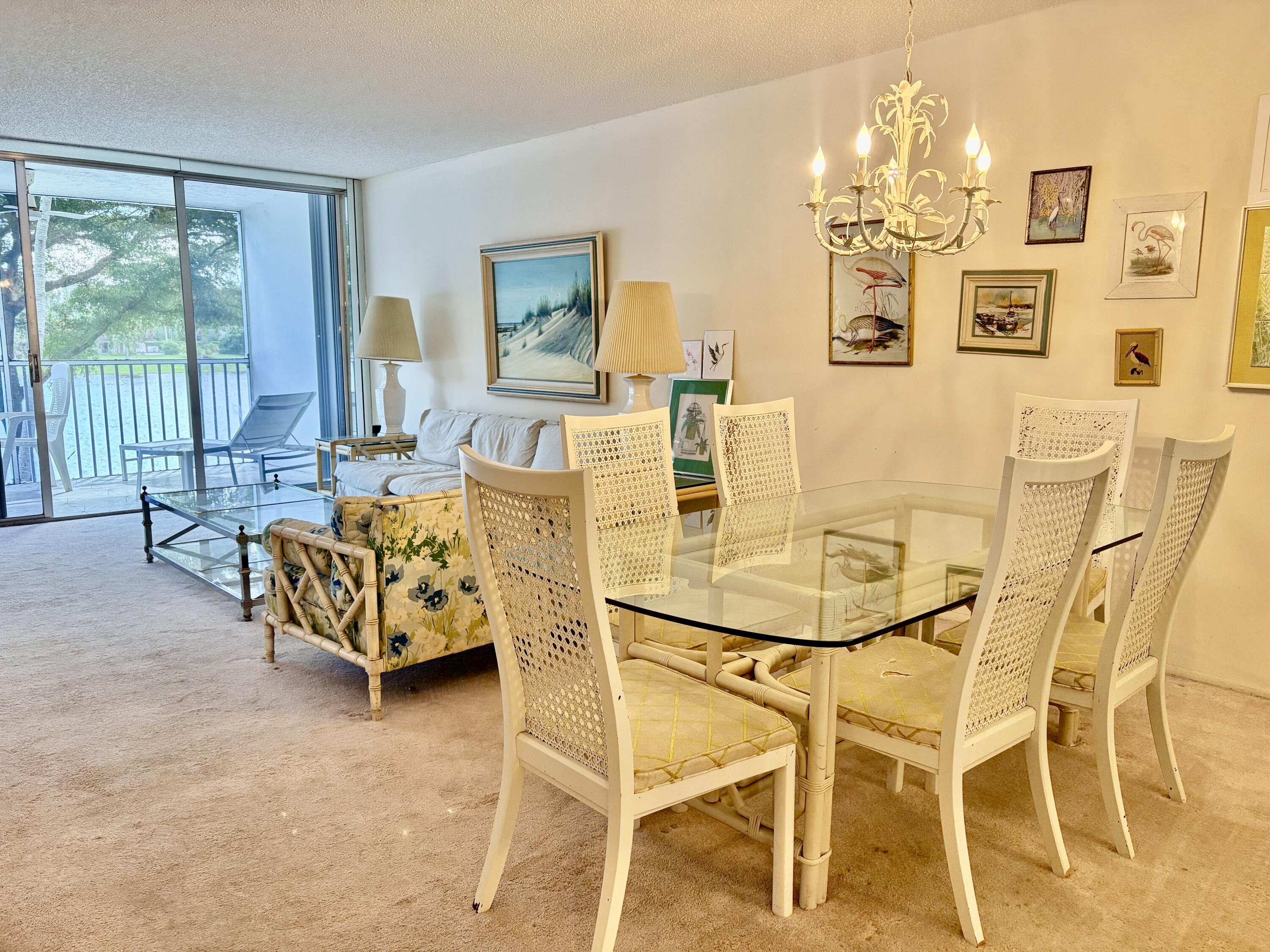 3150 North Course Lane, Unit 202 Pompano Beach, FL 33069 - Photo 7 of 18 a dining room with furniture and chandelier