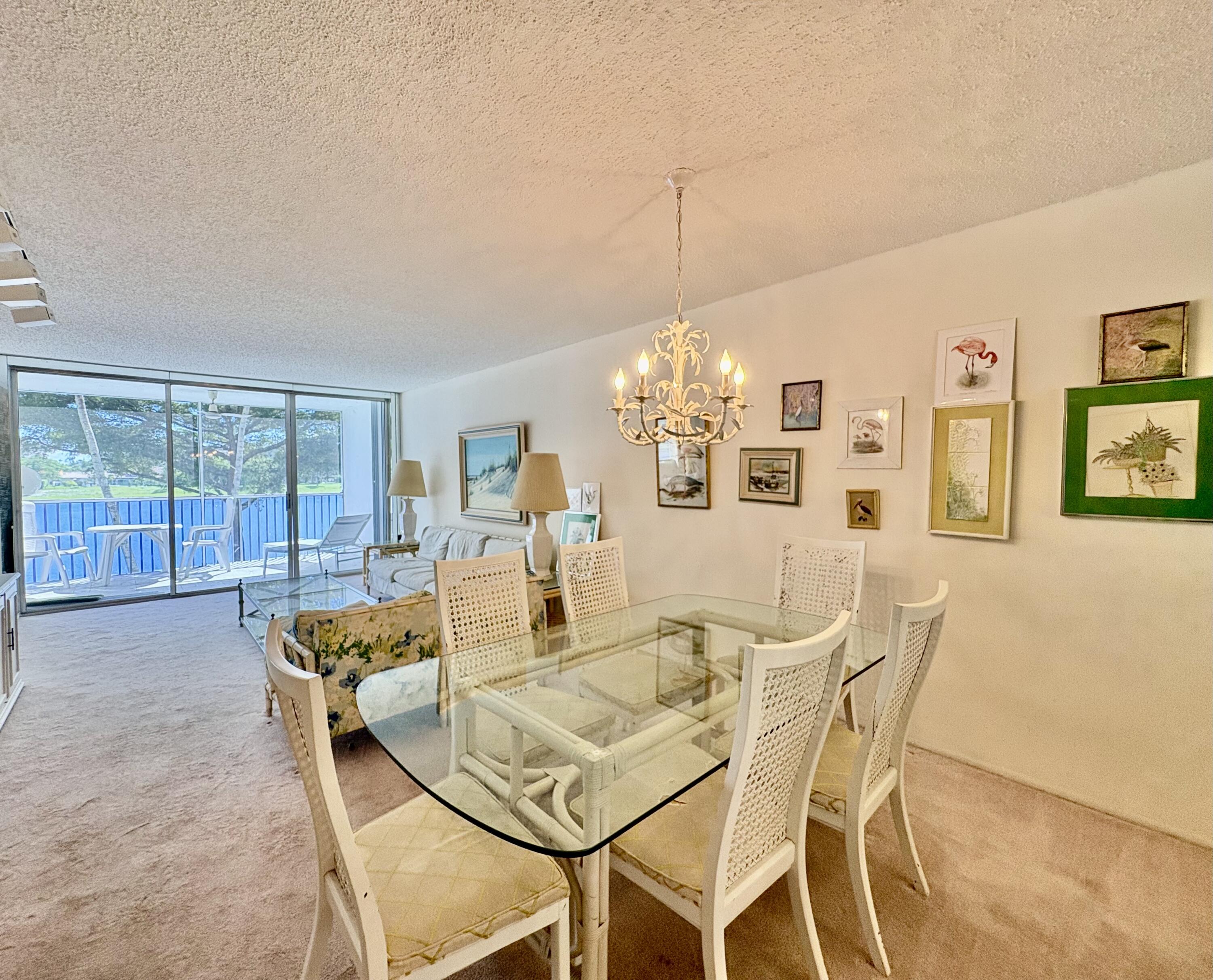 3150 North Course Lane, Unit 202 Pompano Beach, FL 33069 - Photo 8 of 18 a view of a dining room with furniture wooden floor and chandelier