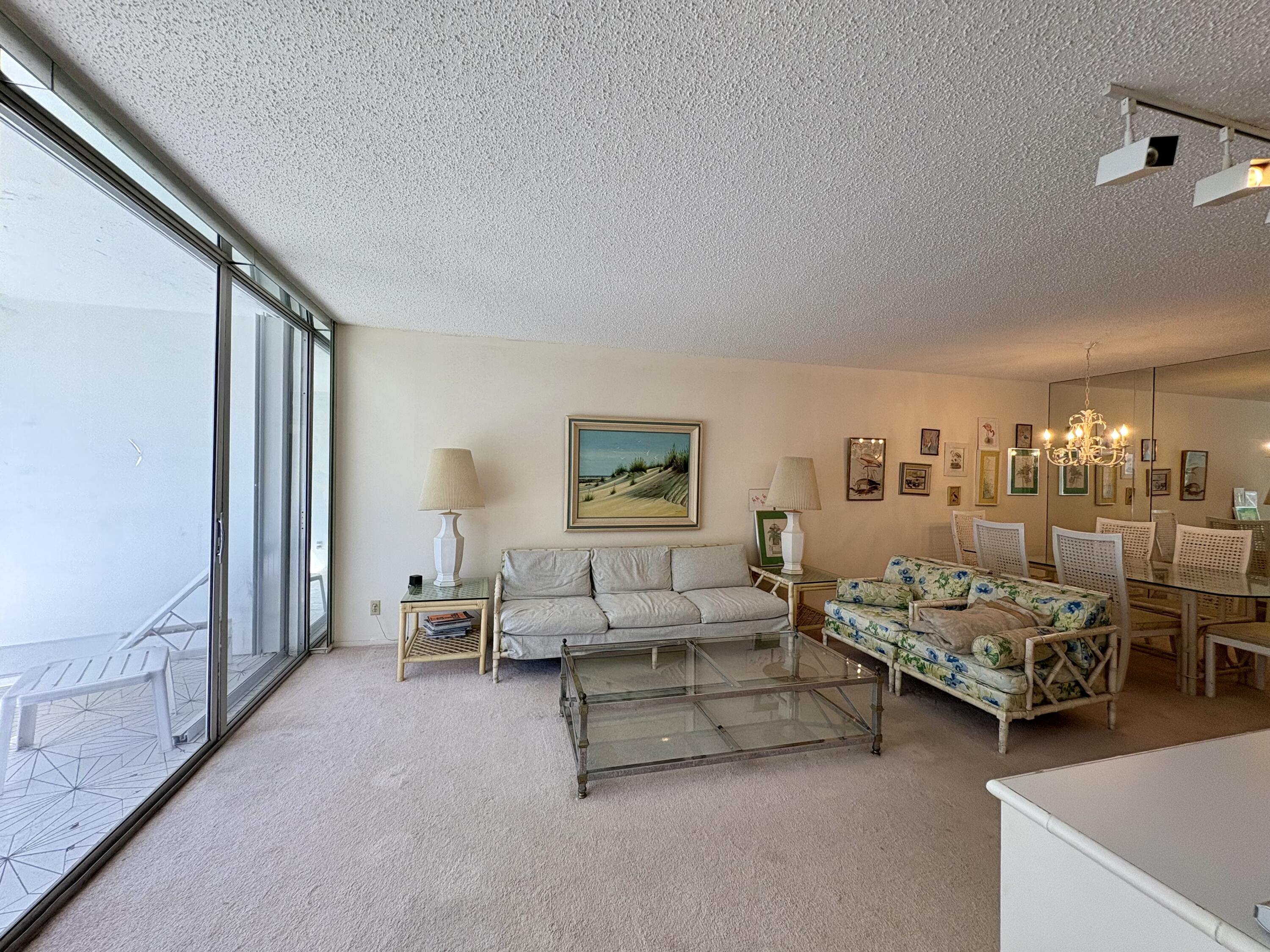 3150 North Course Lane, Unit 202 Pompano Beach, FL 33069 - Photo 9 of 18 a living room with furniture and a window