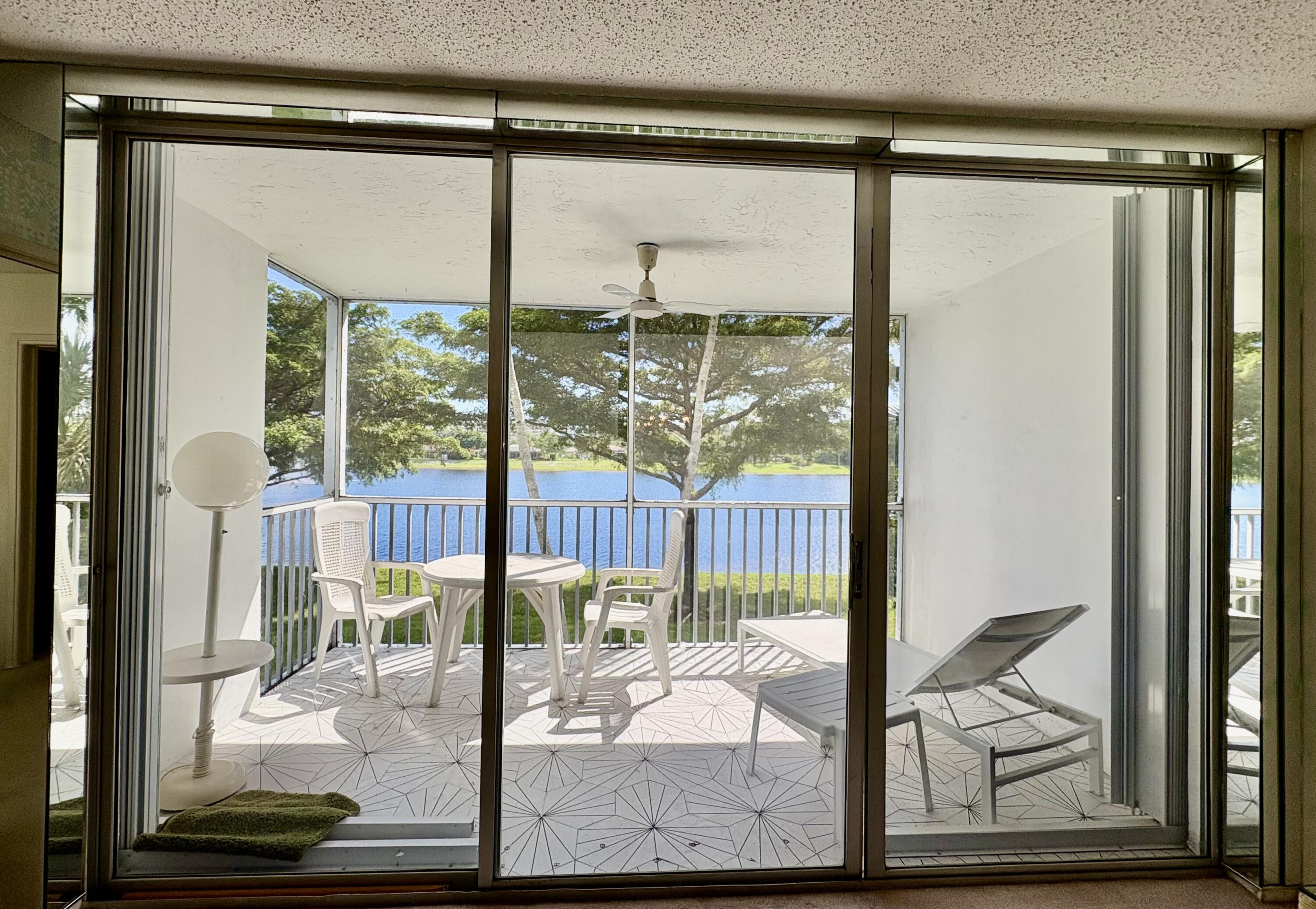 3150 North Course Lane, Unit 202 Pompano Beach, FL 33069 - Photo 10 of 18 a view of a room with a floor to ceiling window