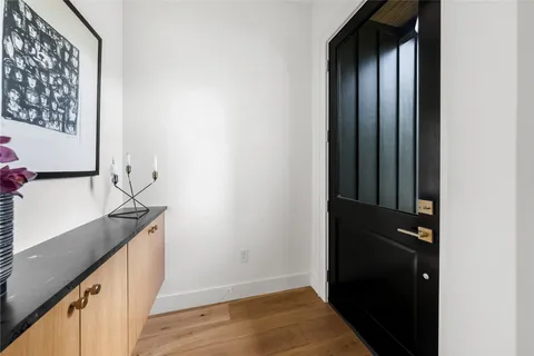 a view of a hallway with wooden floor