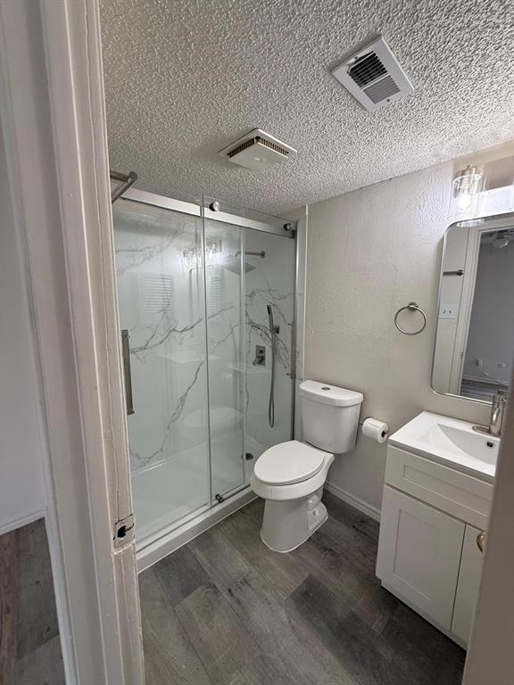 9807 Walnut Street, Unit D 304 Dallas, TX 75243 - Photo 3 of 7 a bathroom with a toilet sink and shower