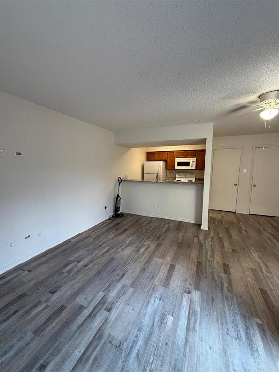 9807 Walnut Street, Unit D 304 Dallas, TX 75243 - Photo 5 of 7 a view of empty room with wooden floor
