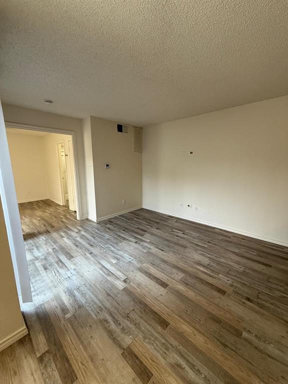 9807 Walnut Street, Unit D 304 Dallas, TX 75243 - Photo 6 of 7 wooden floor in an empty room